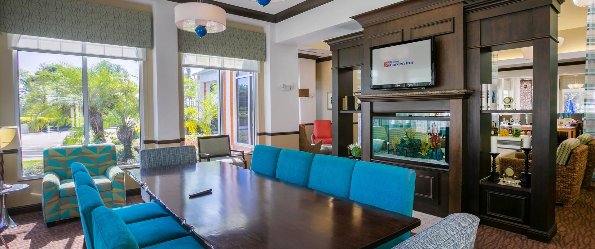 Lobby Seating Area with Chairs, Table, Fish Tank and Wall Mounted HDTV