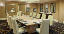 Boardroom with Table, Chairs, Glasses, and Water Bottles