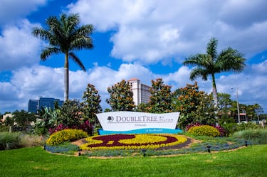 Daytime View of Hotel Signage and Landscaping with Hotel in the Background