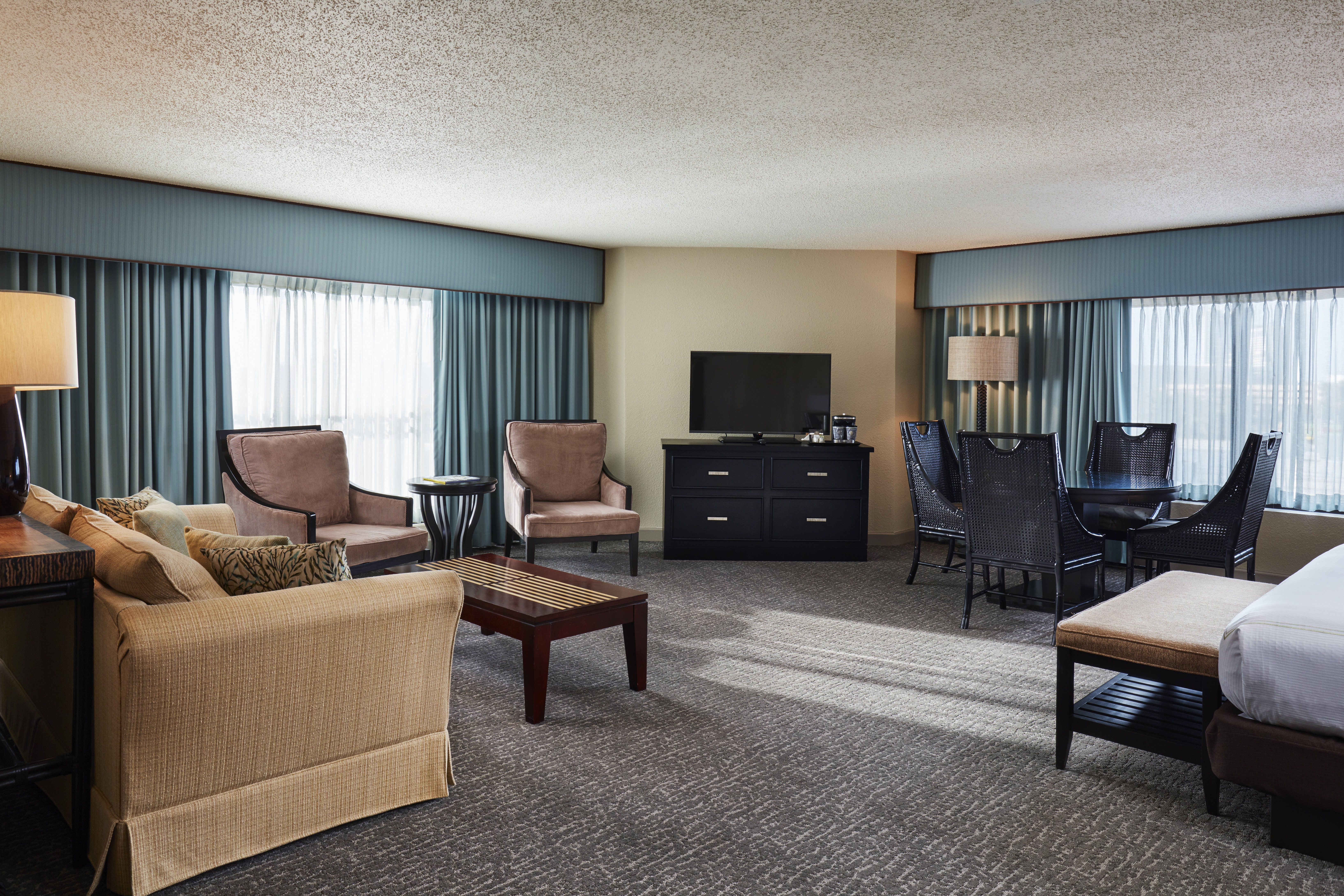 Junior Suite with Bed, Lounge Seating, Table and Television