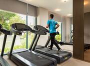 Guest Running on a Treadmill at Hotel Fitness Center