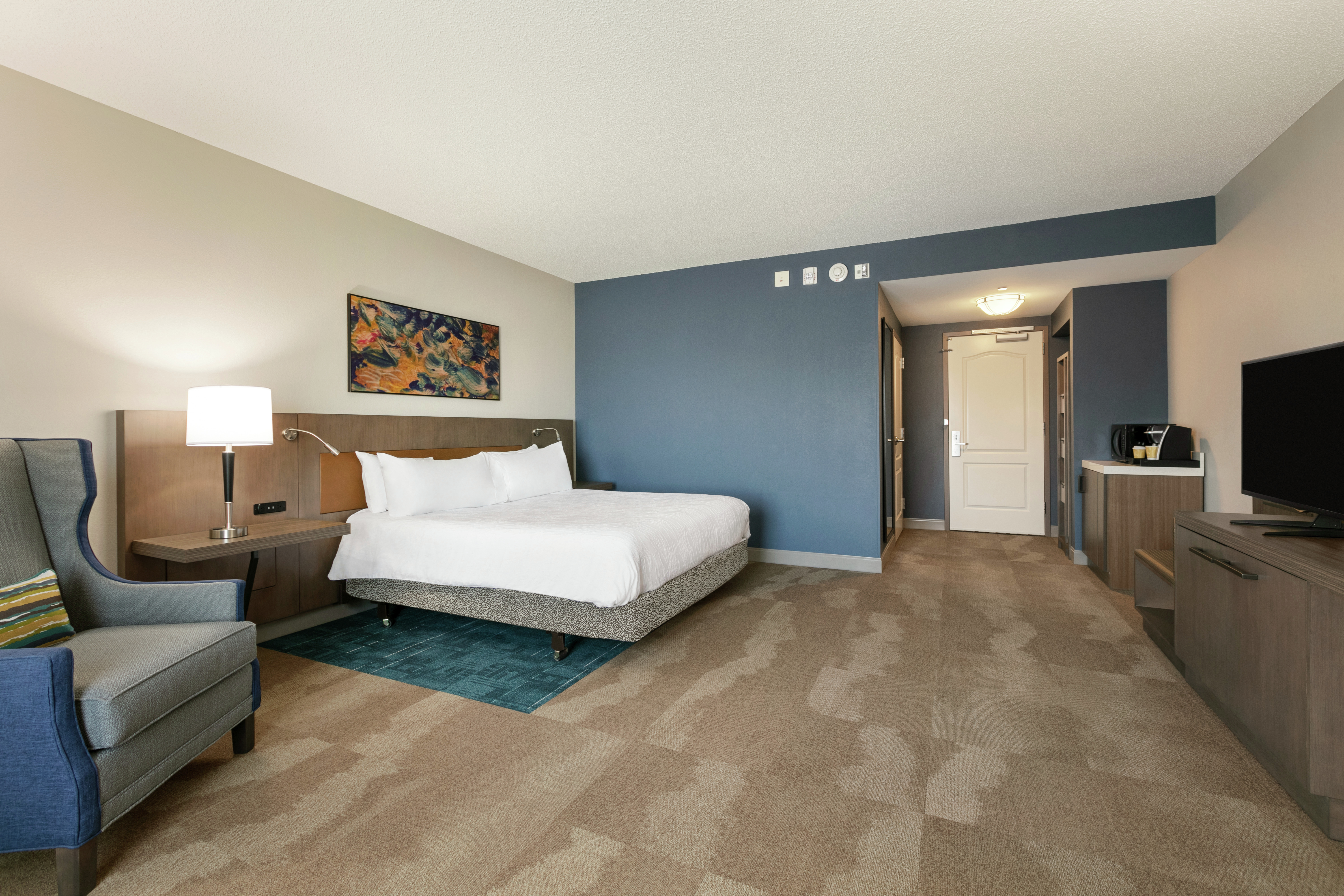 Accessible King Guestroom with Bed, Lounge Area, and Room Technology