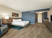 Accessible King Guestroom with Bed, Lounge Area, and Room Technology