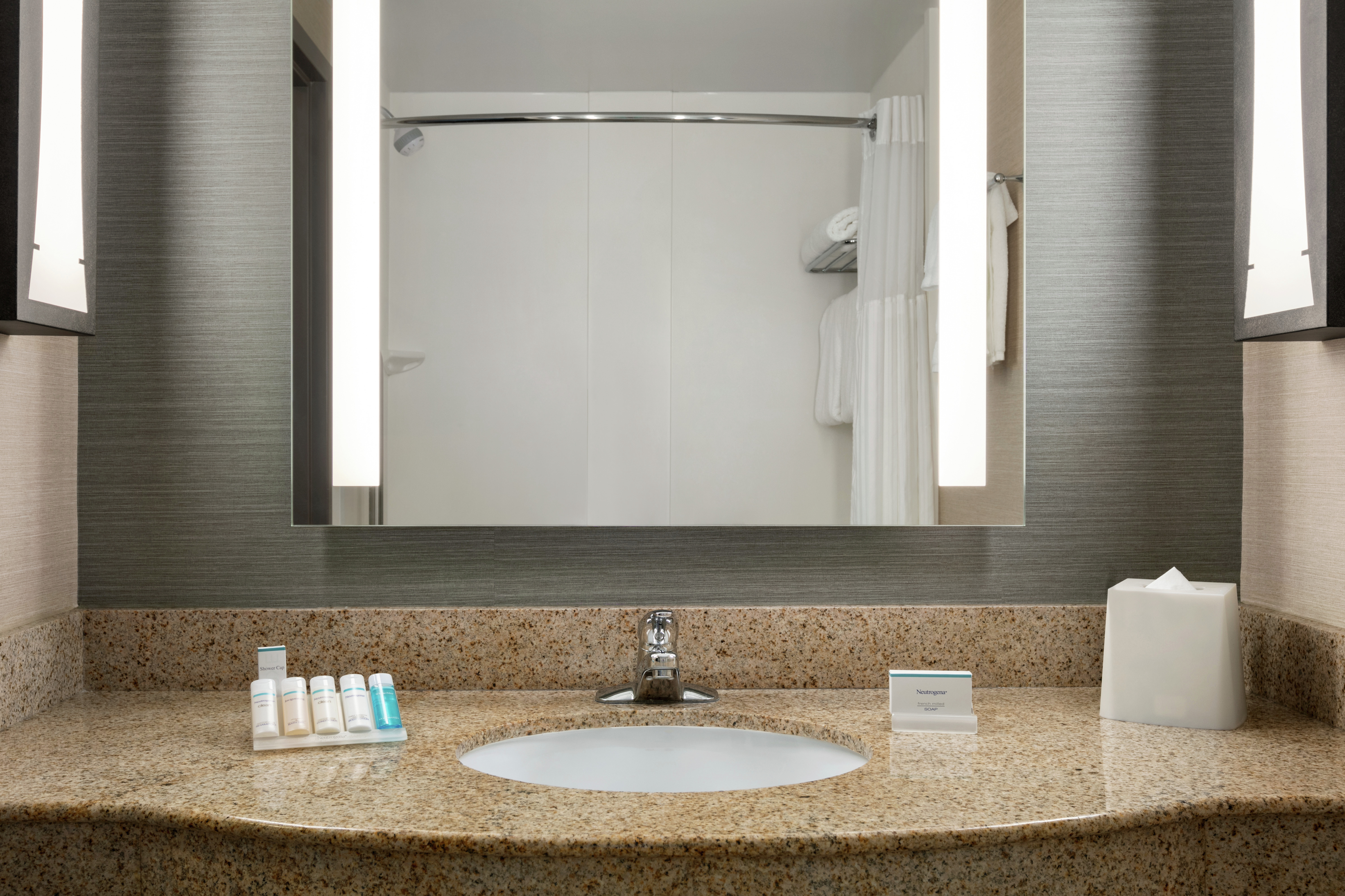 King Guestroom Bathroom with Mirror, Vanity, Shower, and Bathtub