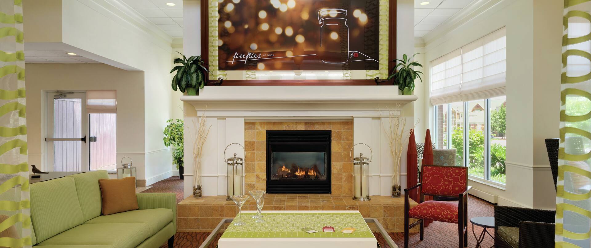 Art Feature Above Fireplace With Lounge Seating in Lobby