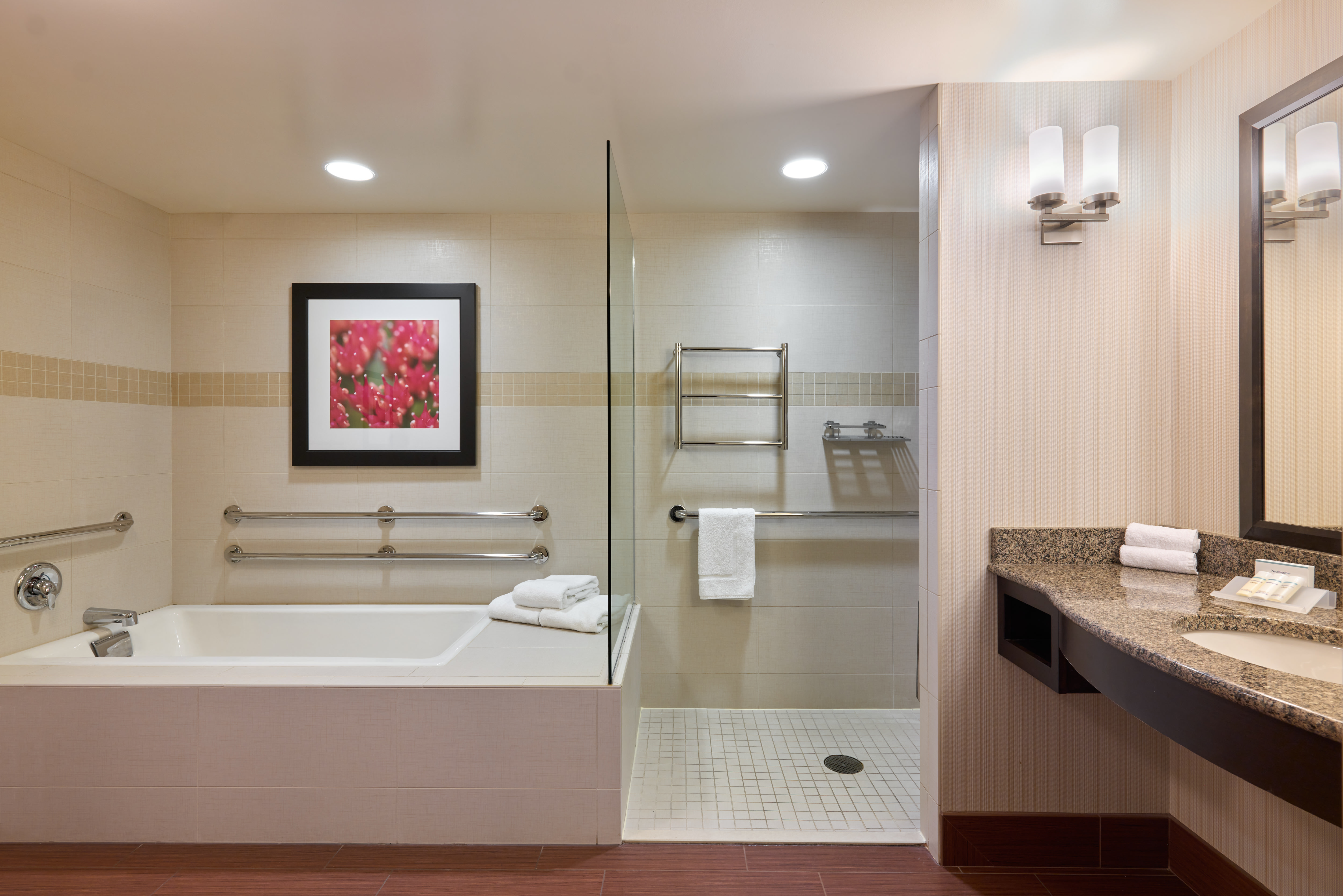 suite bathroom with tub and shower