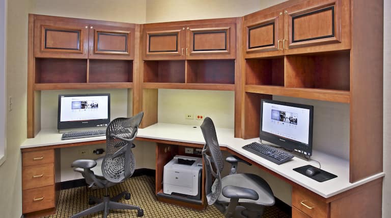 Business Center With Two Computer Workstations, Ergonomic Chairs, and Printer on Large Wooden Desk