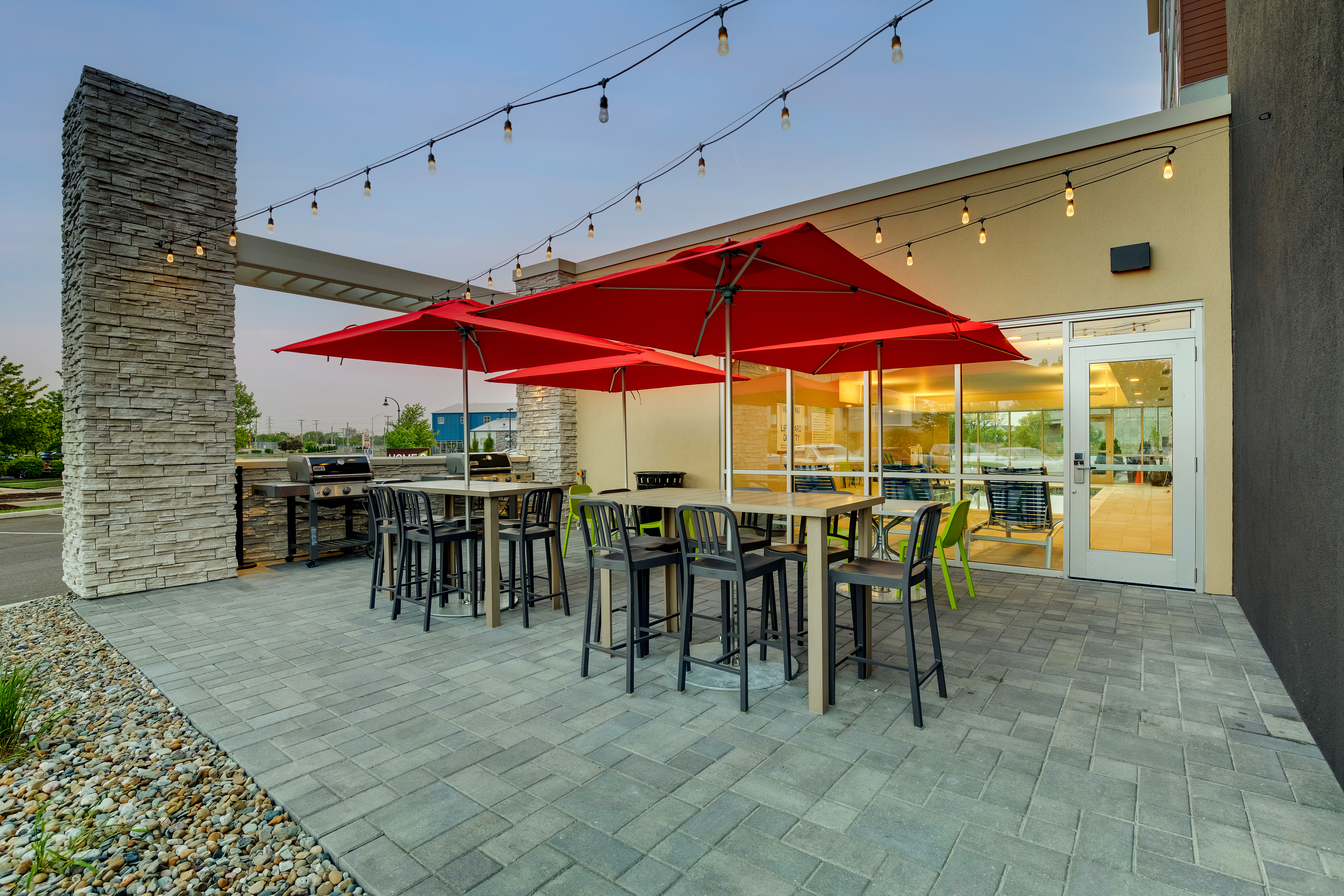 outdoor patio, bbq grills, tables, chairs, umbrellas