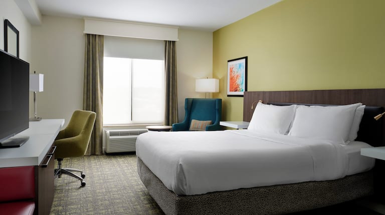 Large Bed, Desk and Armchair in a Guest Room