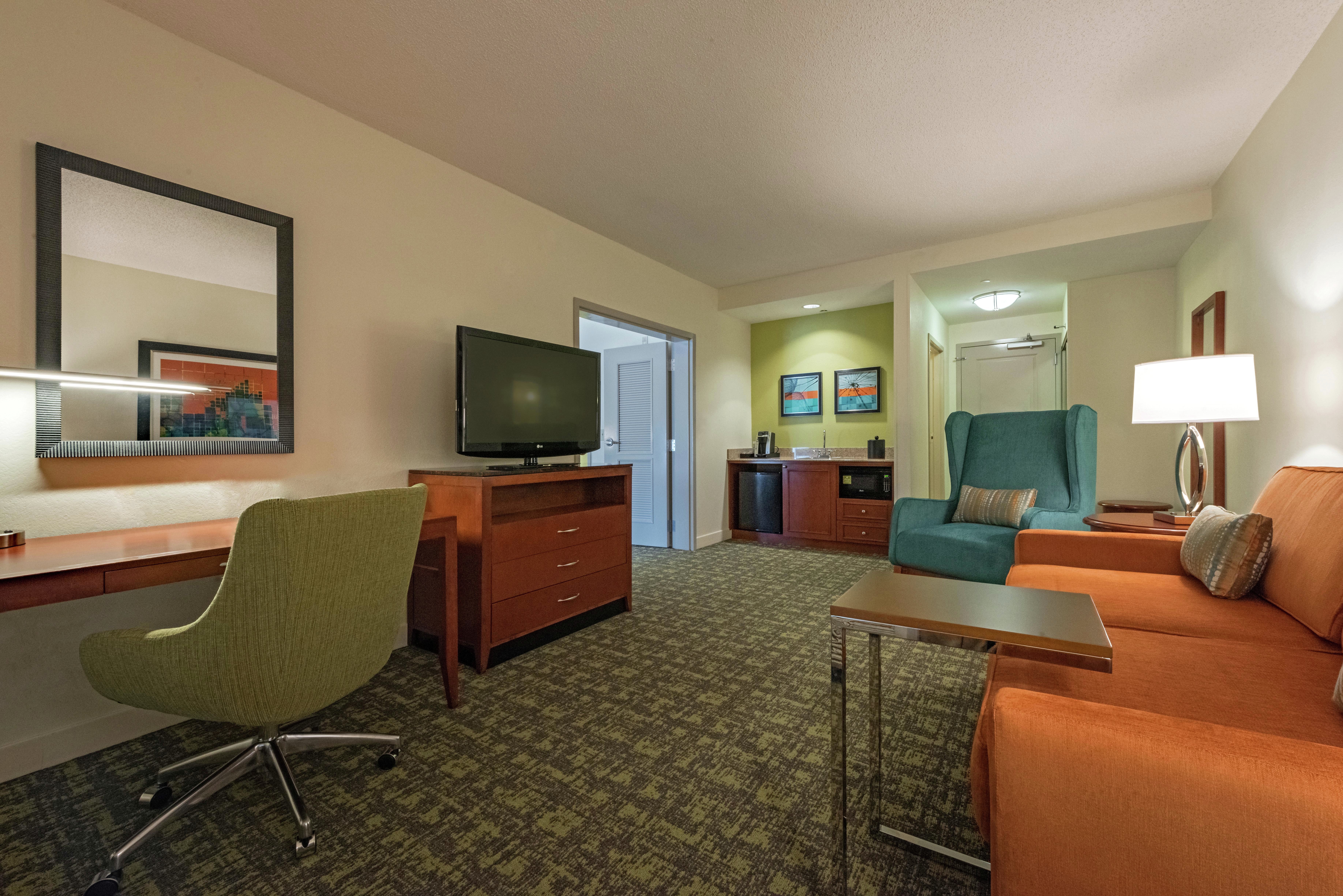 Guestroom Suite with Lounge Area, Work Desk, and Room Technology
