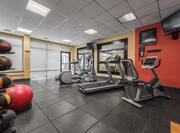 Fitness Center with Treadmill, Cycle Machine, Cross-Trainer, Gym Ball, Medicine Ball Rack and Two Wall Mounted HDTVs