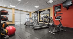 Fitness Center with Treadmill, Cycle Machine, Cross-Trainer, Gym Ball, Medicine Ball Rack and Two Wall Mounted HDTVs