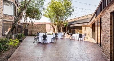 Courtyard set for event with tables and chairs