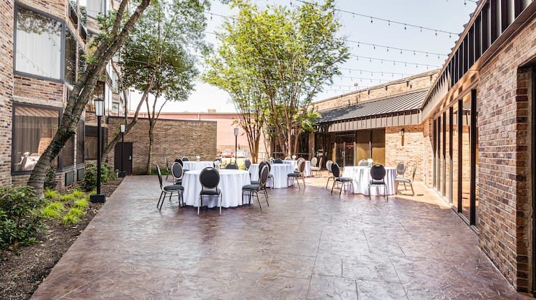 Courtyard set for event with tables and chairs