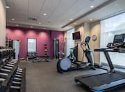 Fitness Center with HDTVs Treadmills Elliptical Machine and Weights