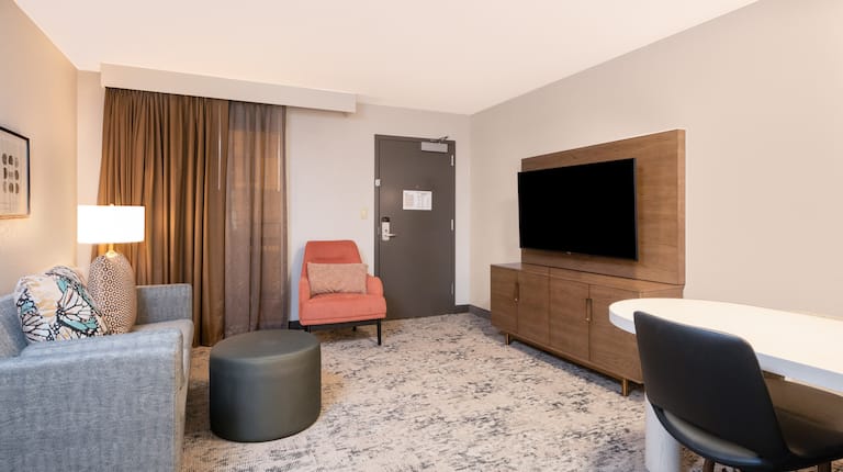 Living Room with HDTV and Desk Area in a Hotel Suite
