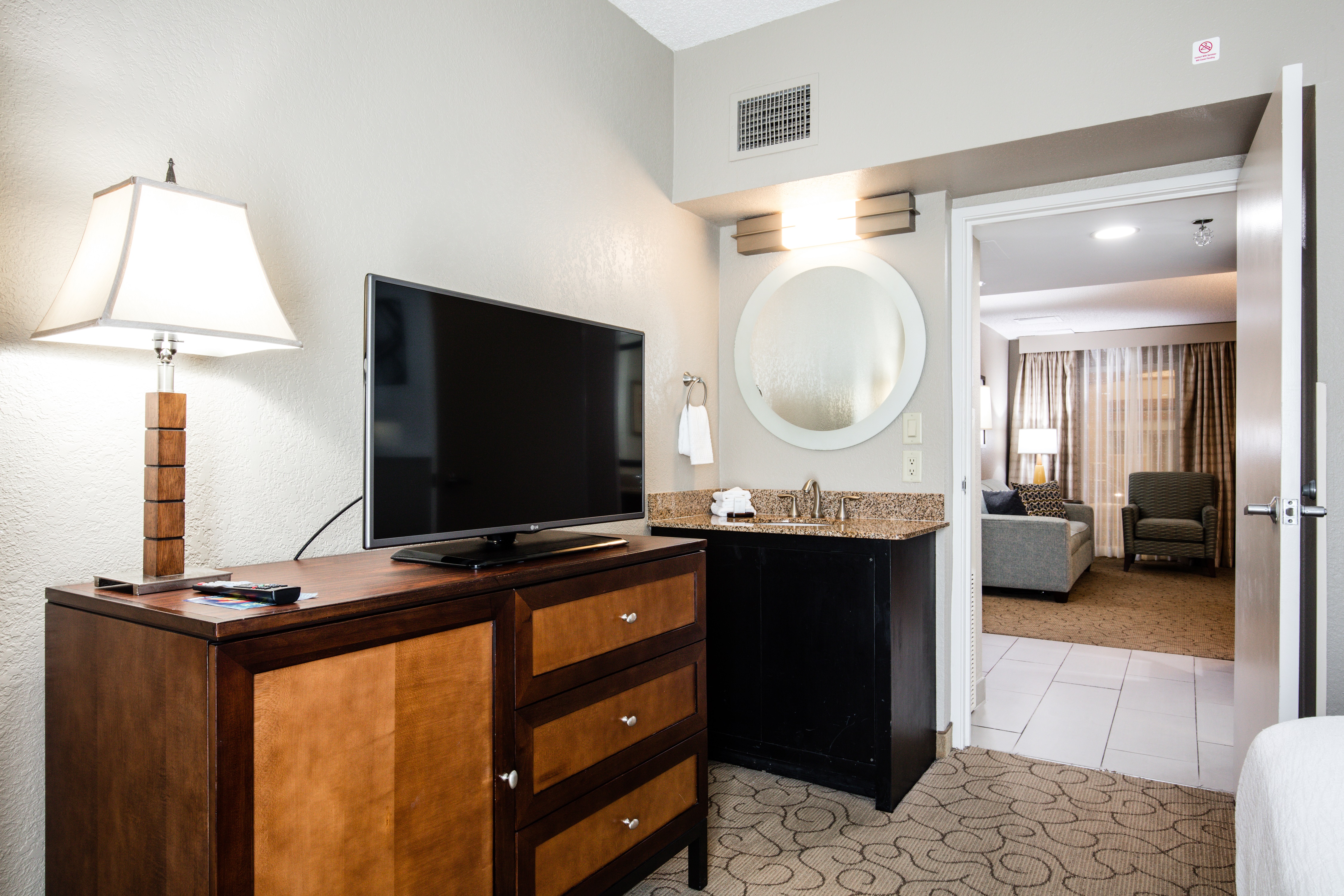 Suite Bedroom with Television, Wet Bar and Entry to Living Room