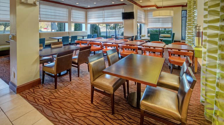 Tables, Chairs and TV in Restaurant Dining Area