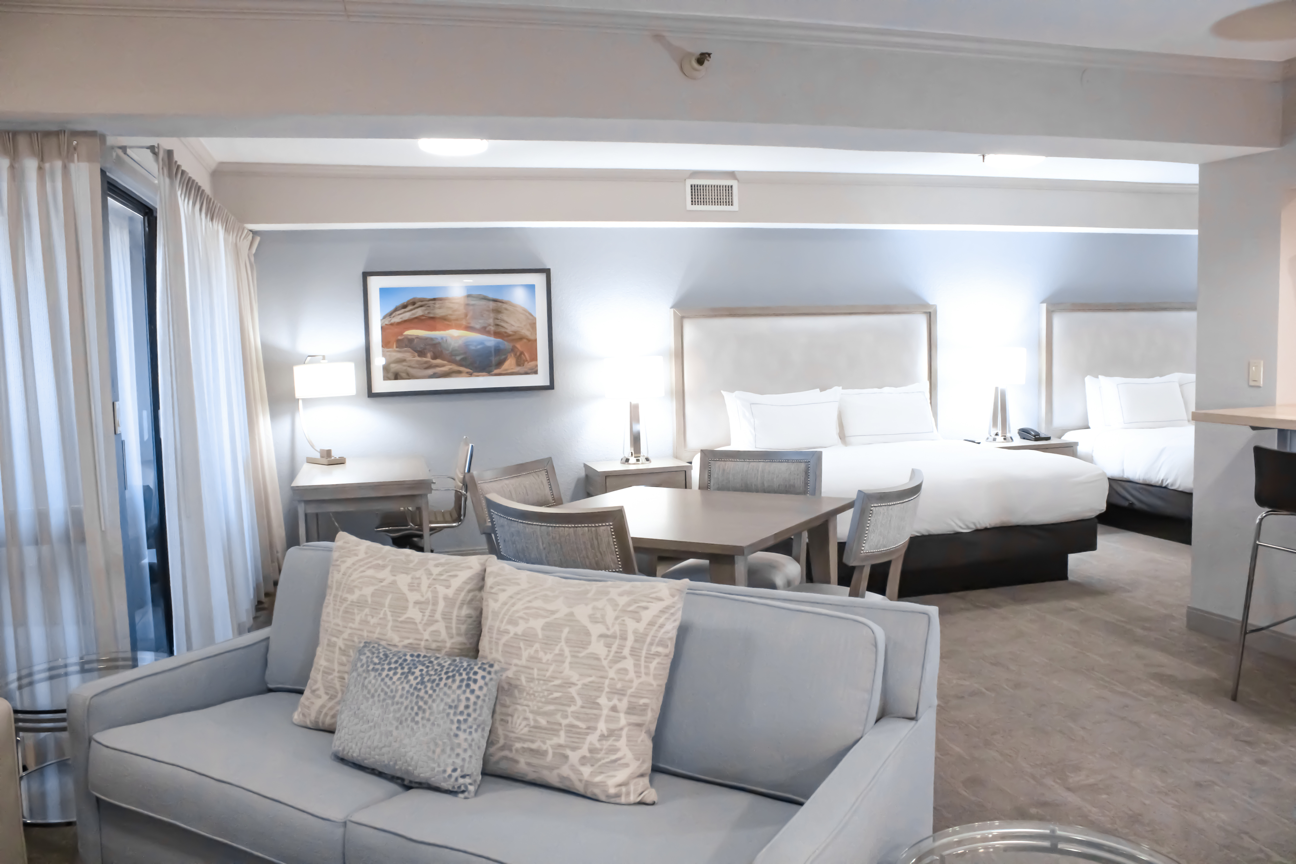 Suite lounge area sofa and two king beds in view