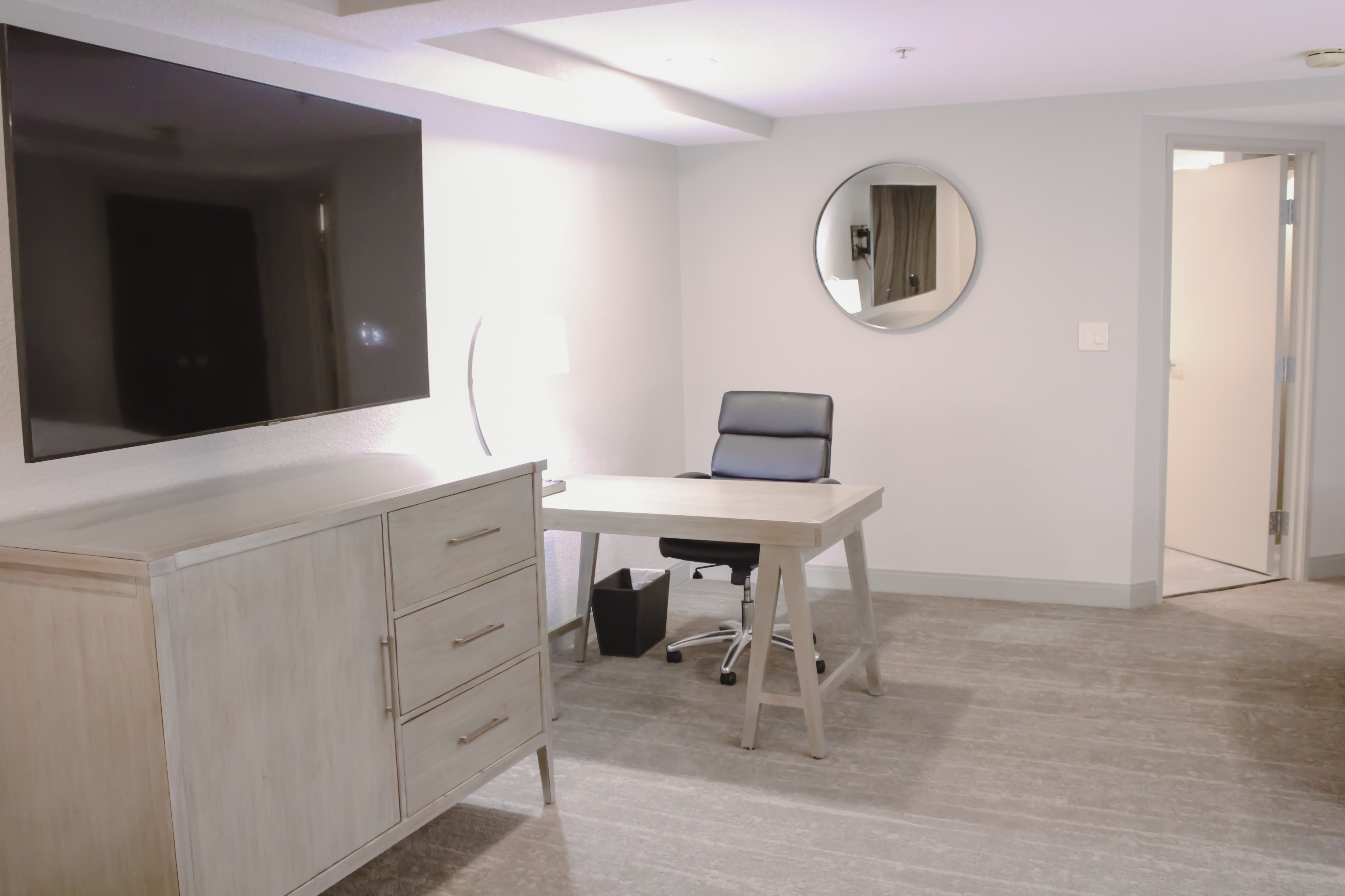Wall mounted TV and work desk with chair
