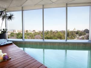 View of Spa Pool with Wooden Decking and Large Window with Expansive View