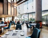 Tables and Chairs in Vianda Restaurant With Large Windows
