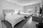 Two beds in guestroom with window