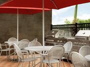 Outdoor Patio with BBQ Grills, Chairs, and Tables with Sun Umbrellas