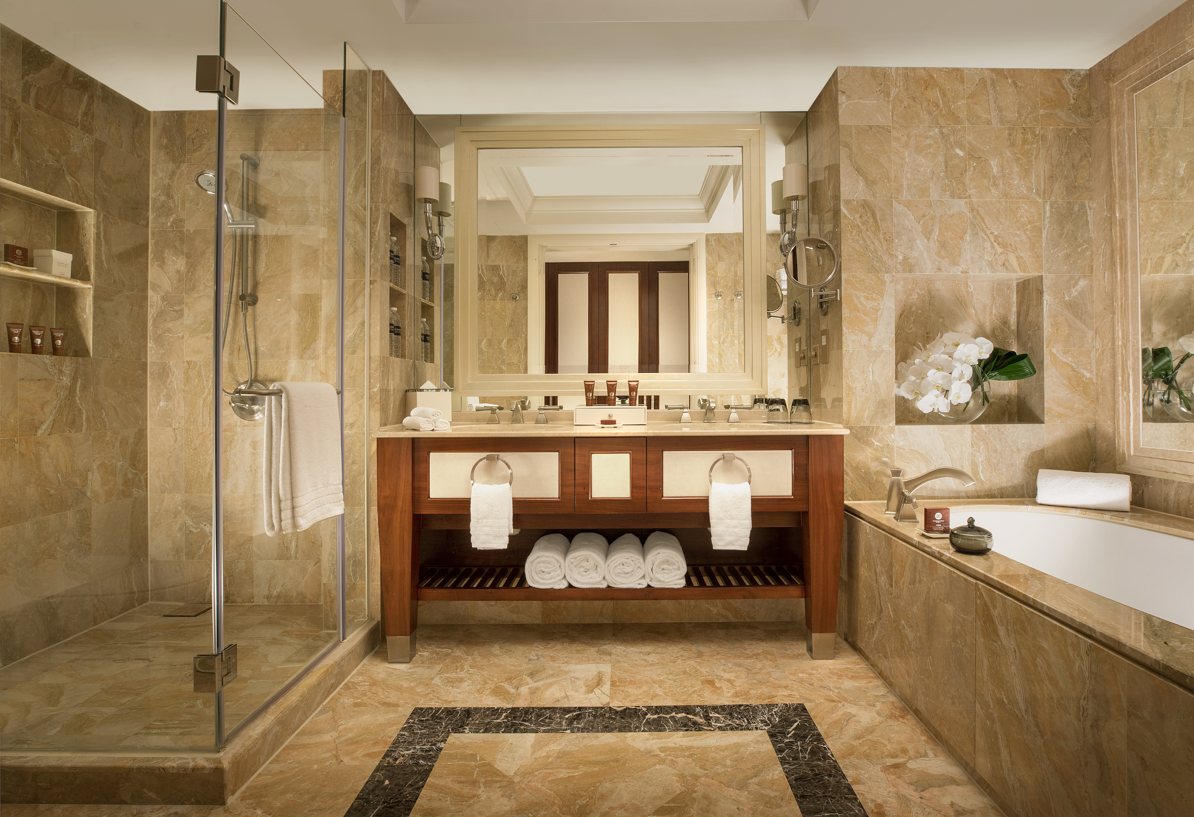 Dual Vanity Area a Bathtub and Separate Shower with Glass Doors in Guest Room