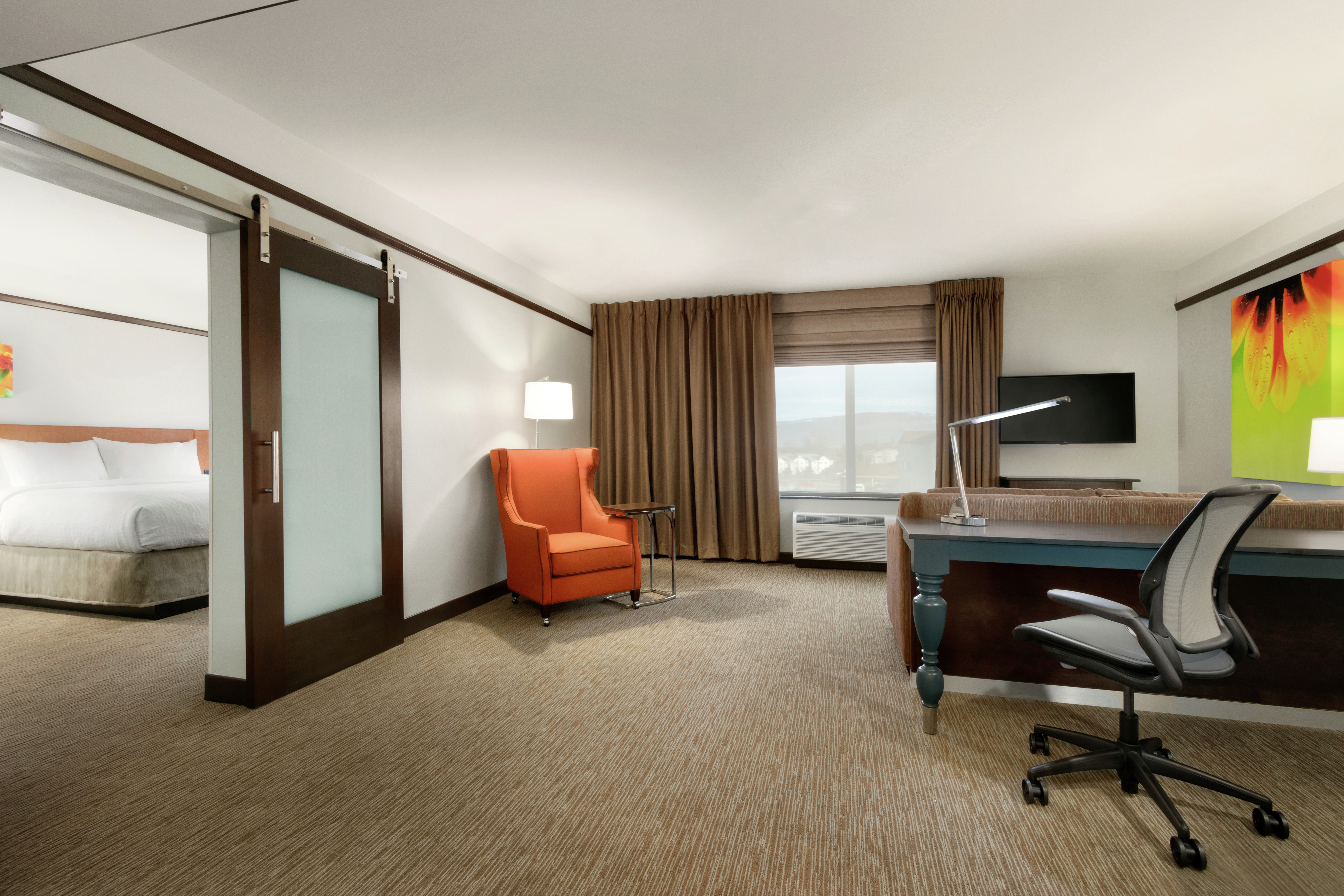 Suite Living Area with Work Desk and Separate Bedroom