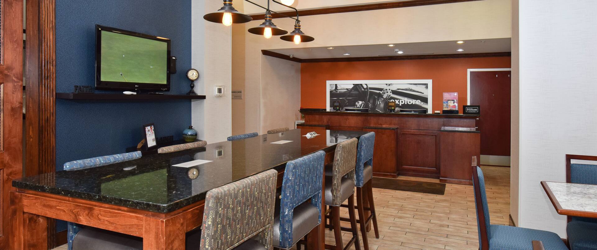 Front Desk Reception Area with Tall Table and Tall Chairs