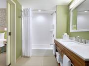 Bathtub, Shower, and Vanity in Suite Bathroom