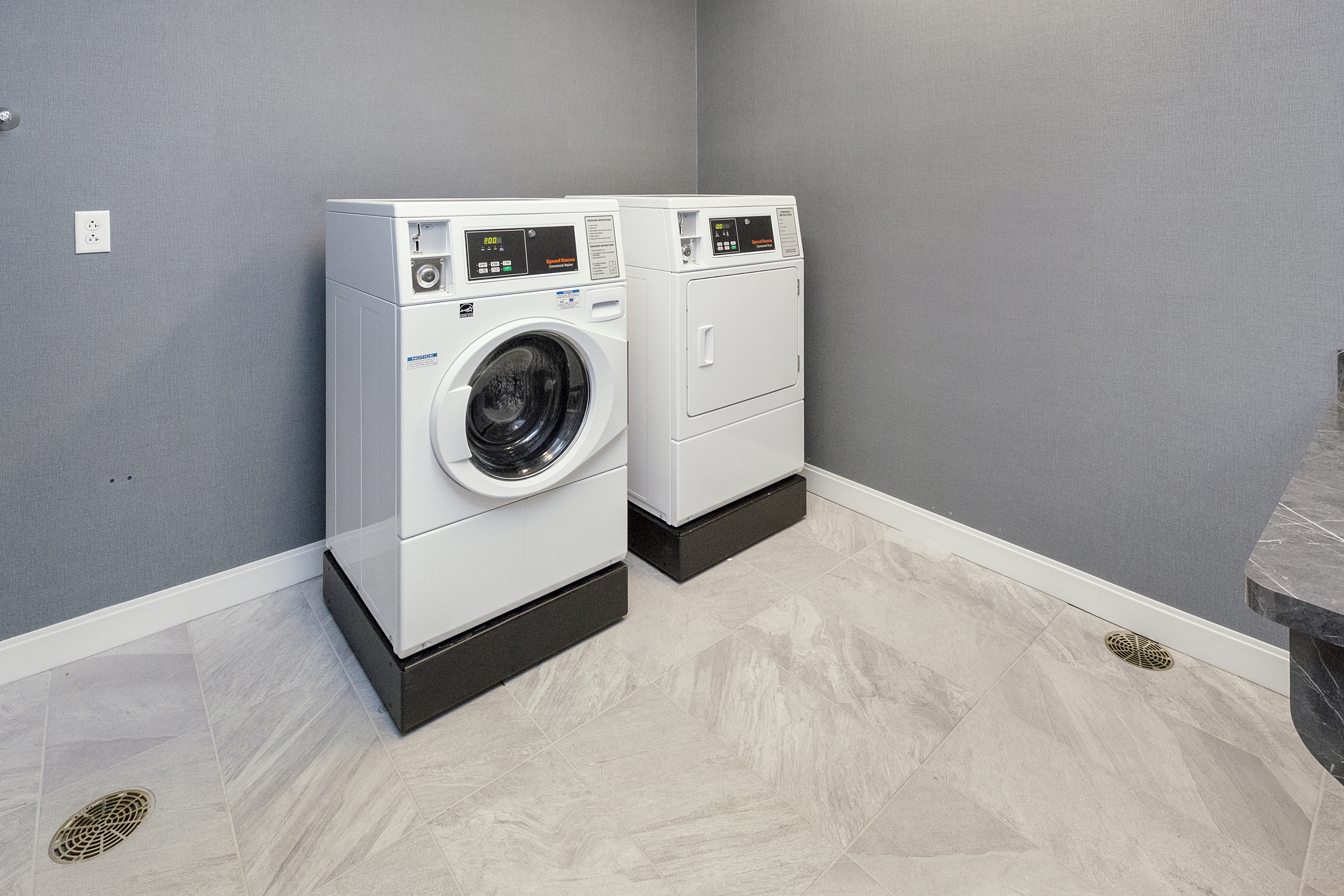 Guest Laundry Room with Two Coin-Operated Washing Machines