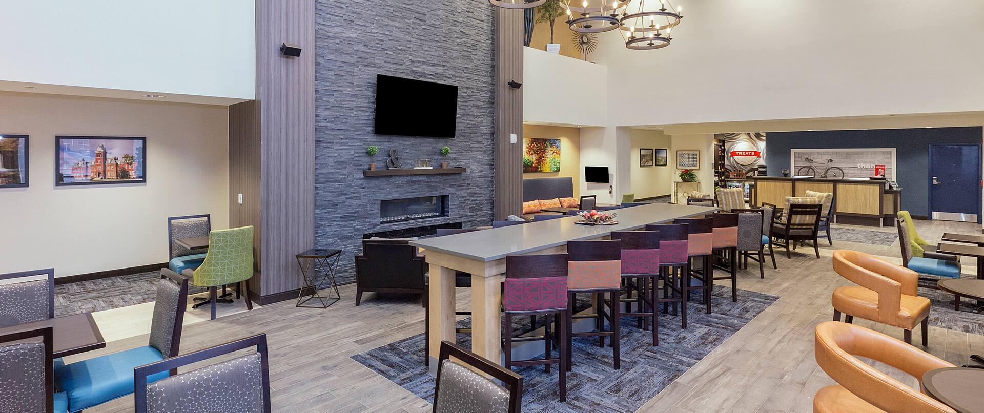 Breakfast Dining Area with Chairs, Tables and Wall Mounted HDTV