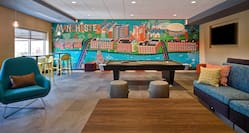 lobby seating area with pool table and mural