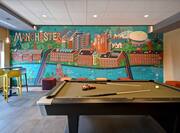 lobby with pool table and mural