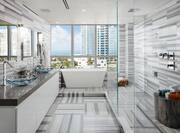 Penthouse bathroom with dual vanity area bathtub and large windows with city view