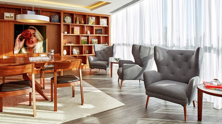 Library Lounge Area with Tables and Armchairs