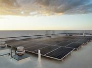 Eco-friendly energy generating solar panels on hotel rooftop.