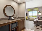 Bright suite featuring lounge convenient in-room wet bar, sofa, and beautiful outside view.