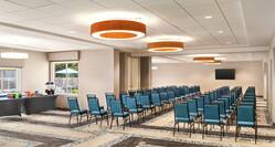 Spacious on-site meeting space featuring large theater setup, TV, and refreshment station.