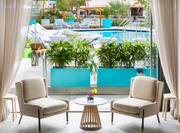 Lobby Seating Area with Two Soft Chairs, Small Table and Outdoor Pool