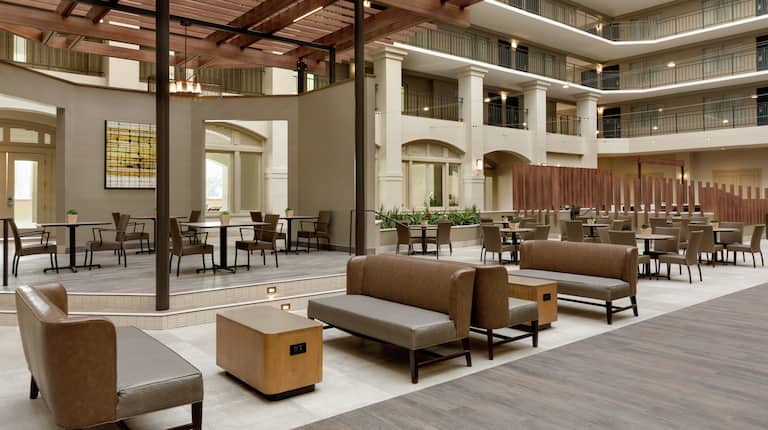 Open concept hotel atrium featuring stylish design and ample seating for guests to relax.