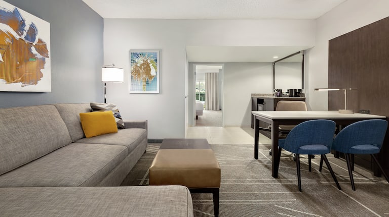 Spacious mountain view suite living area featuring sofa, dining table, and wet bar.