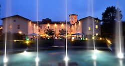 Water Fountain and Hotel Exterior at Night