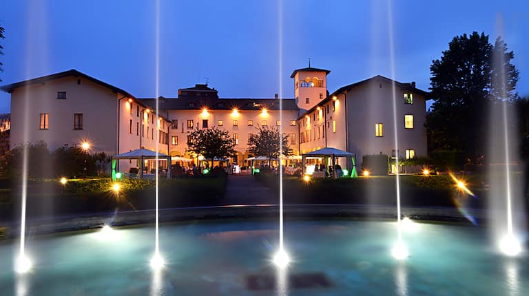 Water Fountain and Hotel Exterior at Night