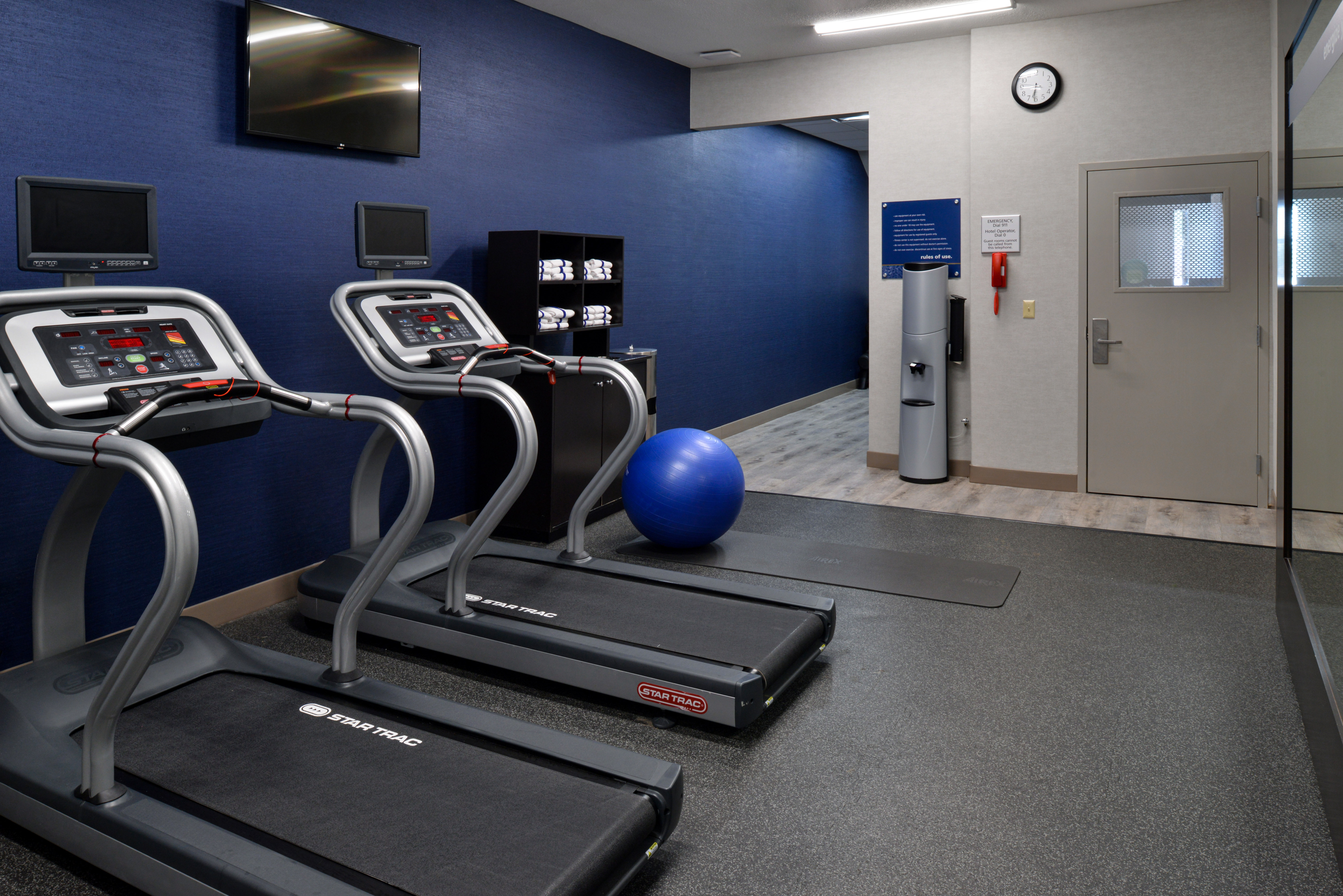Fitness center with cardio machines and TV