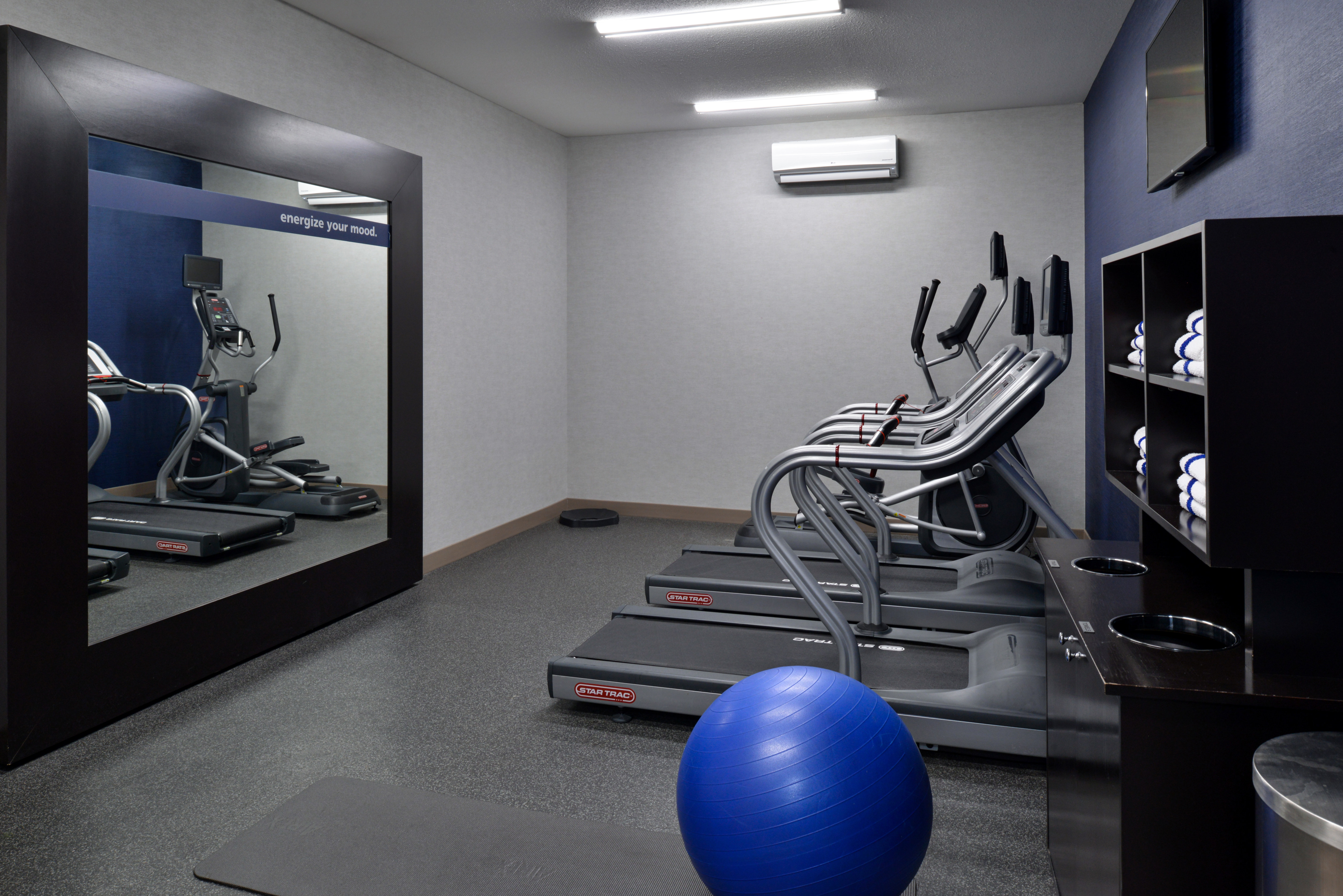 Fitness center with cardio machines and mirror