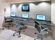 Business Center With Three Computer Workstations and Chairs