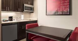 Suite Kitchen with Microwave, Stove Top, Dishwasher and Table